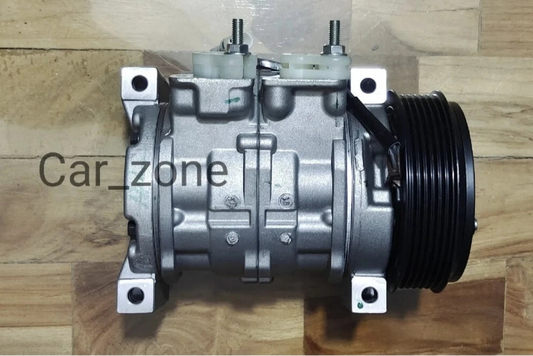 Car air conditioning compressor on a wooden surface with promotional text about free express shipping.